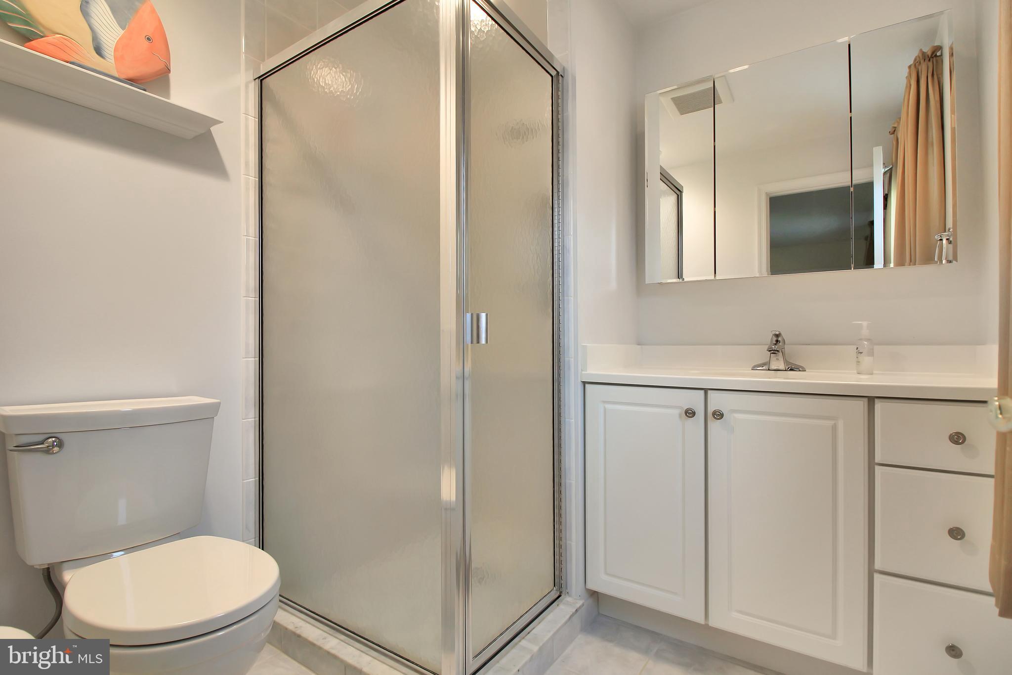 9702 Wynmill Road Philadelphia, PA 19115 - Photo 29 of 35 a bathroom with a granite countertop sink toilet and shower