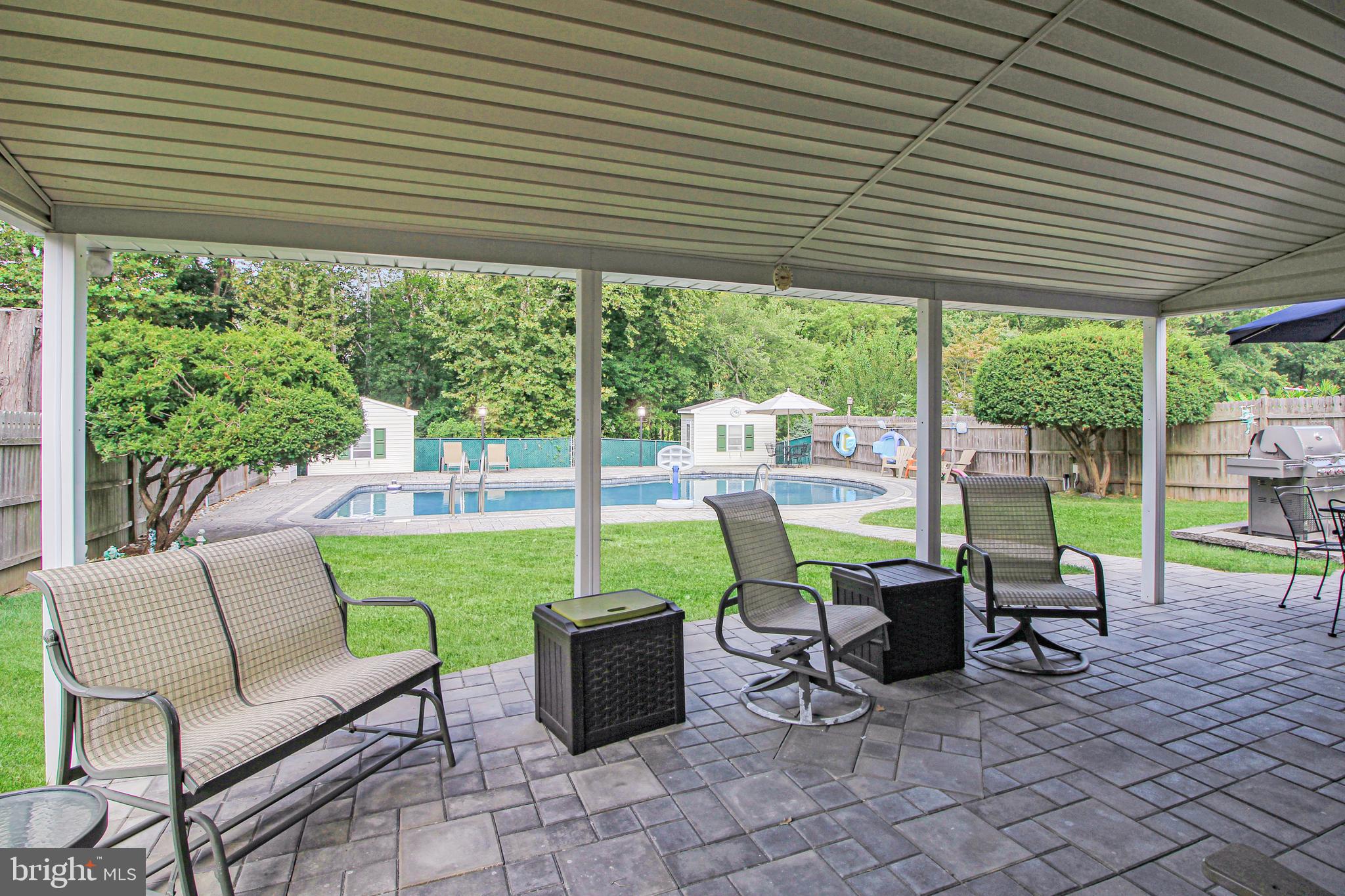 9702 Wynmill Road Philadelphia, PA 19115 - Photo 8 of 35 a view of a patio with a table chairs and a backyard