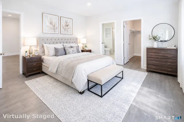 a bedroom with a bed a closet and a painting