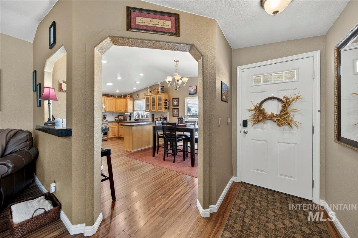 421 South Curtis Road, Unit 118 Boise, ID 83705 - Photo 13 of 49 Foyer featuring light wood-style floors, suspended lighting, and arched walkways