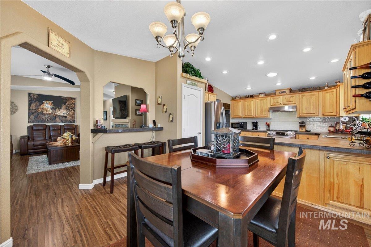 421 South Curtis Road, Unit 118 Boise, ID 83705 - Photo 15 of 49 Dining room with dark wood-style floors, a ceiling fan, lofted ceiling, and hanging lights