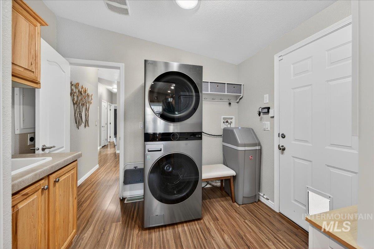 421 South Curtis Road, Unit 118 Boise, ID 83705 - Photo 22 of 49 Laundry area featuring dark wood-type flooring, stacked washer and dryer, and lofted ceiling