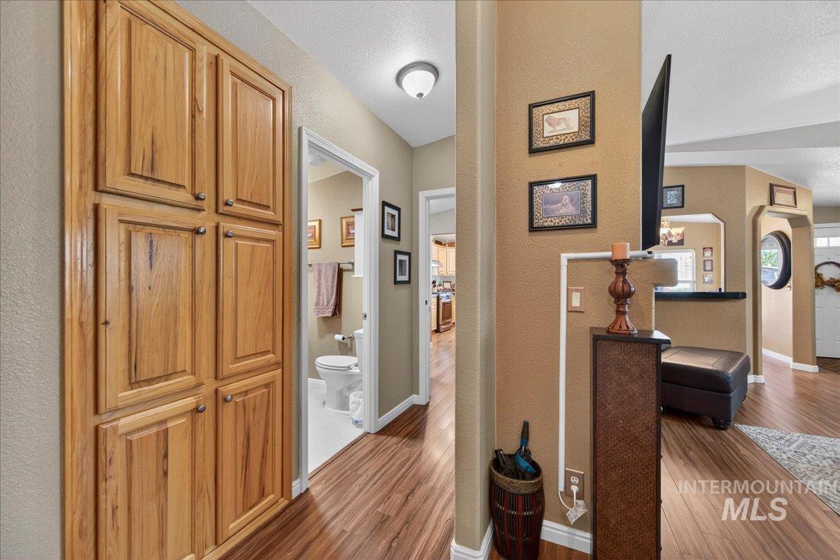 421 South Curtis Road, Unit 118 Boise, ID 83705 - Photo 24 of 49 Hallway with dark wood-type flooring and a textured wall