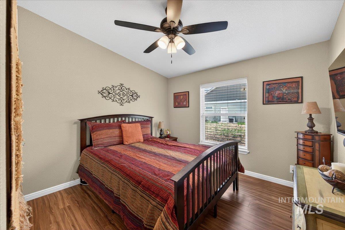 421 South Curtis Road, Unit 118 Boise, ID 83705 - Photo 26 of 49 Bedroom with dark wood-style flooring and a ceiling fan