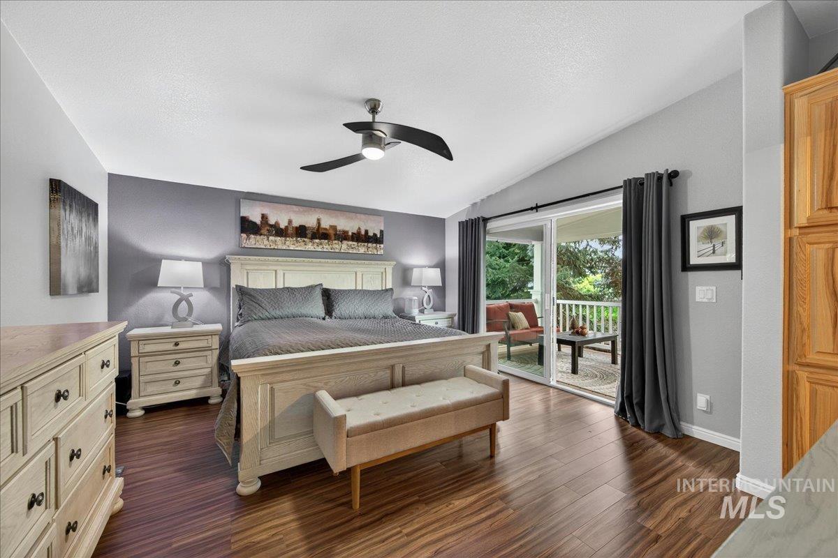 421 South Curtis Road, Unit 118 Boise, ID 83705 - Photo 28 of 49 Bedroom featuring dark wood-style flooring, access to outside, a ceiling fan, and vaulted ceiling
