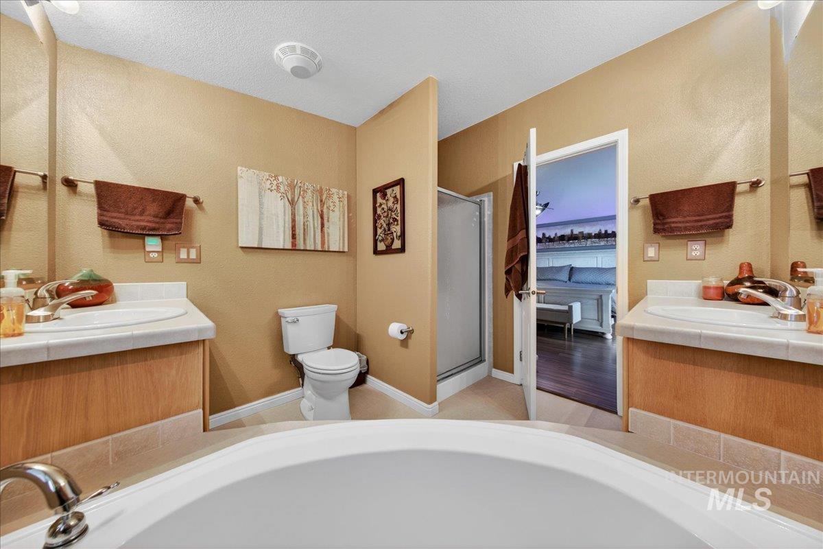 421 South Curtis Road, Unit 118 Boise, ID 83705 - Photo 34 of 49 Full bath with vanity, a stall shower, and a garden tub