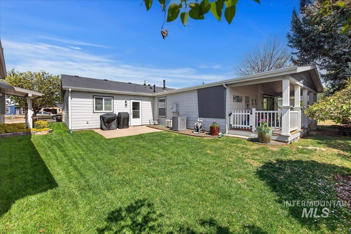 421 South Curtis Road, Unit 118 Boise, ID 83705 - Photo 43 of 49 Back of property with a lawn and a patio area