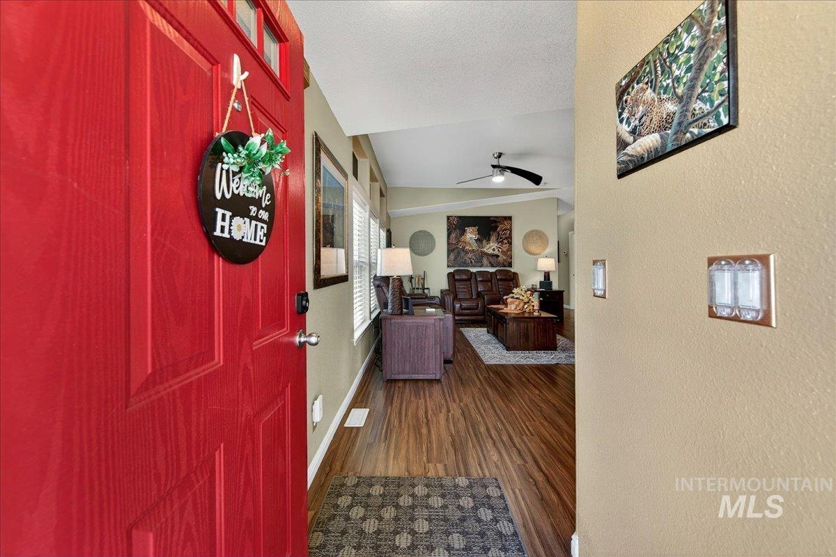 421 South Curtis Road, Unit 118 Boise, ID 83705 - Photo 7 of 49 Foyer entrance with a ceiling fan, dark wood-style flooring, and a textured wall