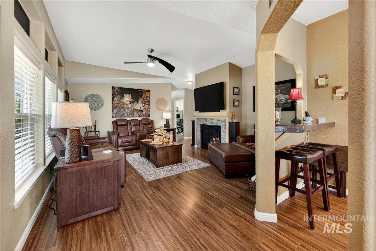 421 South Curtis Road, Unit 118 Boise, ID 83705 - Photo 8 of 49 Living room with a warm lit fireplace, dark wood finished floors, ceiling fan, and lofted ceiling