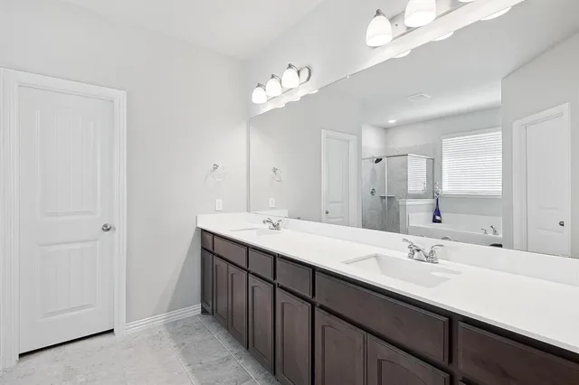 a bathroom with a double vanity sink and a mirror