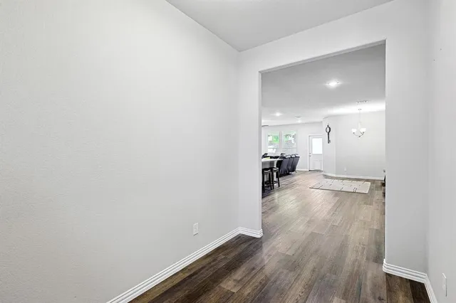 a view of a room with wooden floor