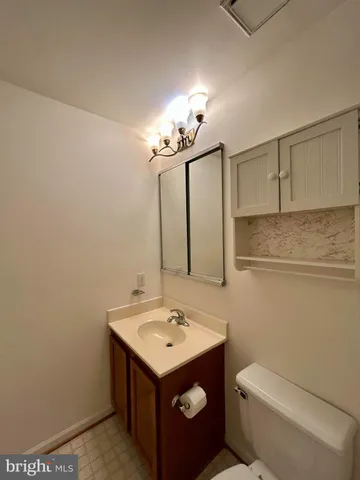 a bathroom with a sink toilet and mirror