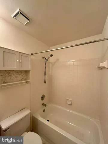 a bathroom with a shower and a toilet