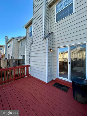 a view of a balcony with wooden floor and fence