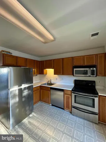 a kitchen with stainless steel appliances granite countertop a sink and cabinets