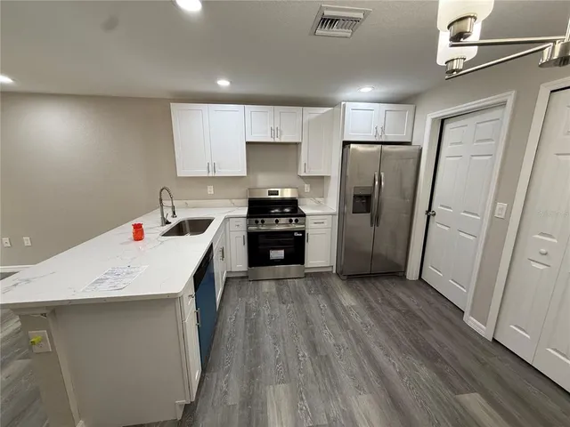 a kitchen with a refrigerator a sink and dishwasher