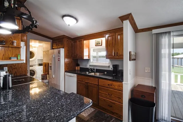 a kitchen with stainless steel appliances granite countertop a stove a refrigerator and a sink