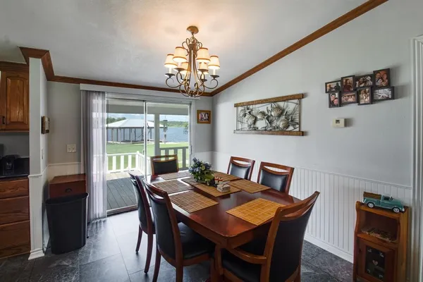 a view of a dining room with furniture wooden floor and chandelier