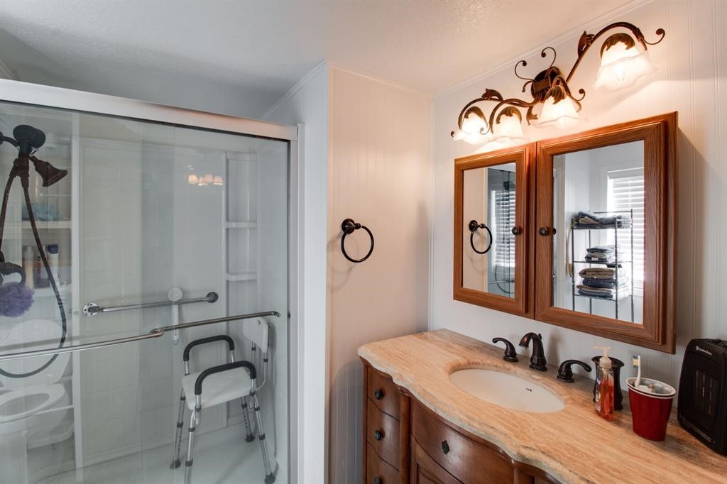 122 Read Oak Onalaska, TX 77360 - Photo 15 of 34 a bathroom with a granite countertop sink mirror and vanity