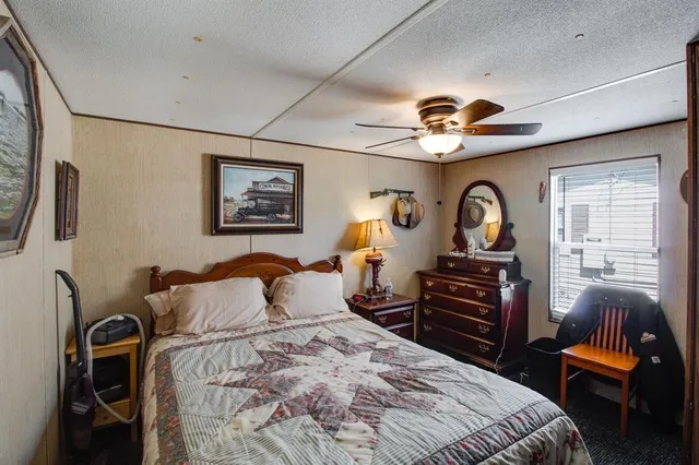 a bedroom with furniture a bed and a chandelier