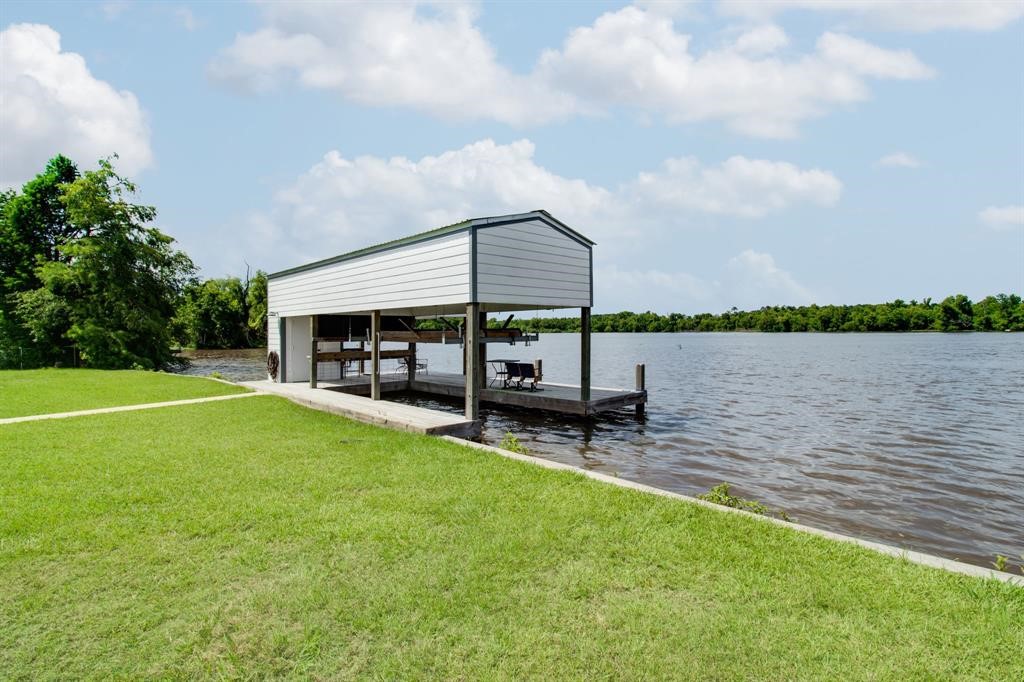 122 Read Oak Onalaska, TX 77360 - Photo 23 of 34 a view of a lake with a table and a chair