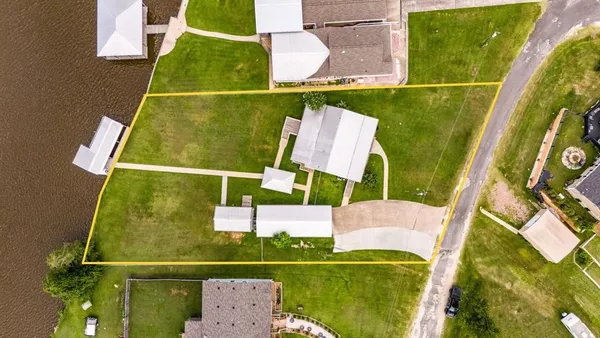 an aerial view of a house with a yard table and chairs