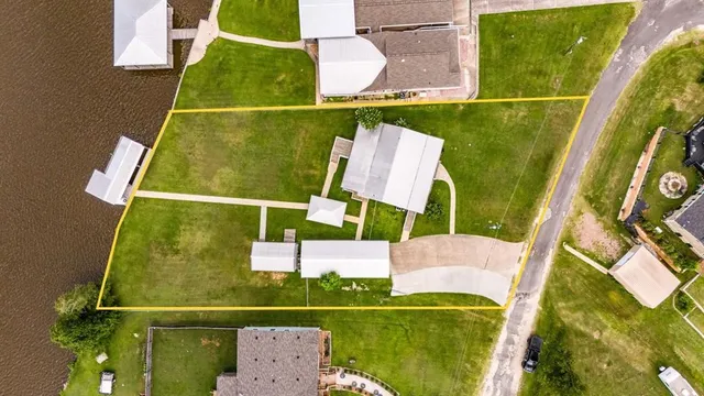 an aerial view of a house with a yard table and chairs