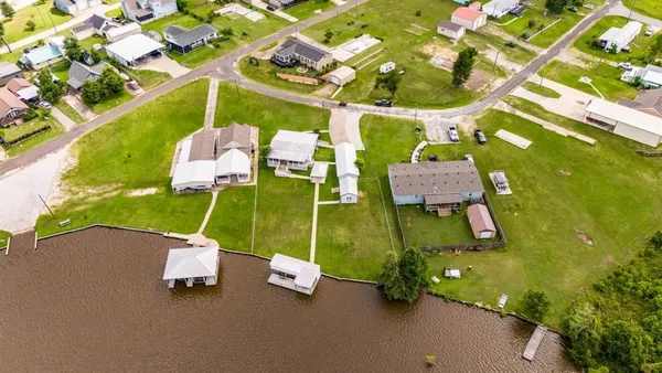 a aerial view of a house with a garden and lake view