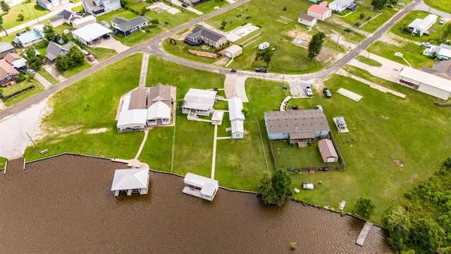 a aerial view of a house with a garden and lake view