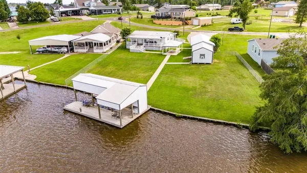 an aerial view of a house with garden space and outdoor seating