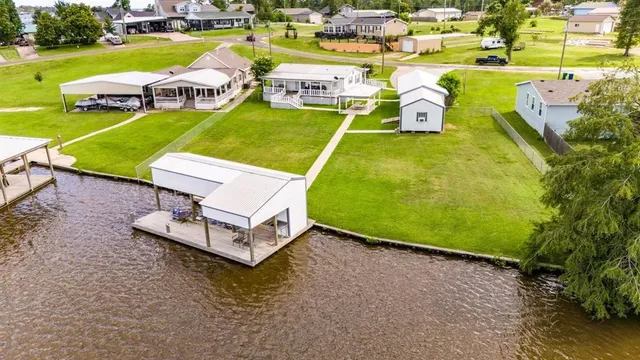 an aerial view of a house with garden space and outdoor seating