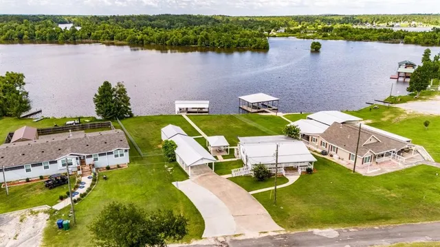 an aerial view of a house with outdoor space pool seating area and yard