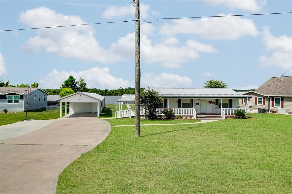 122 Read Oak Onalaska, TX 77360 - Photo 3 of 34 a front view of a house with a yard