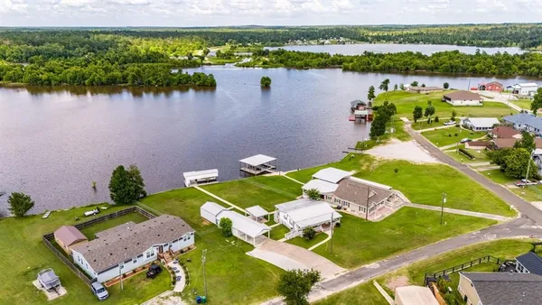 an aerial view of a house with a lake view