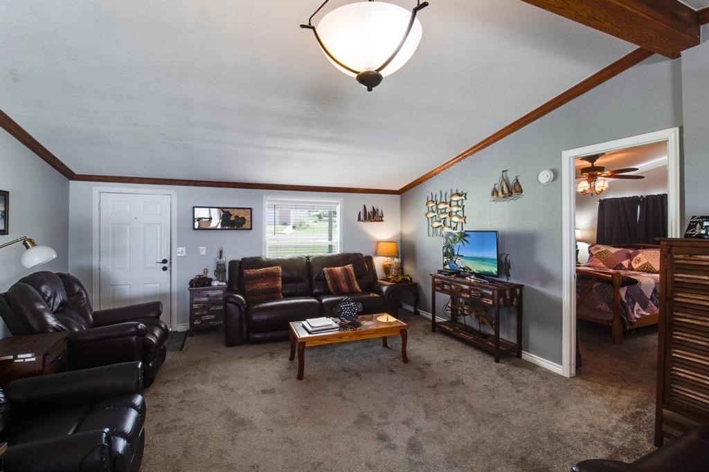 122 Read Oak Onalaska, TX 77360 - Photo 7 of 34 a living room with furniture and a flat screen tv