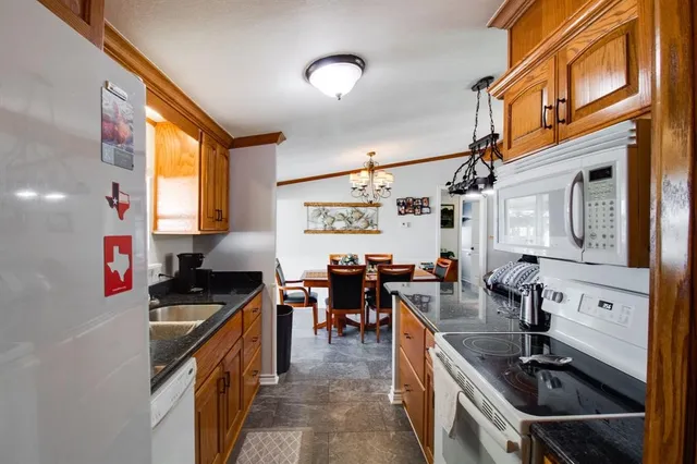 a kitchen filled with stainless steel appliances a sink stove and cabinets