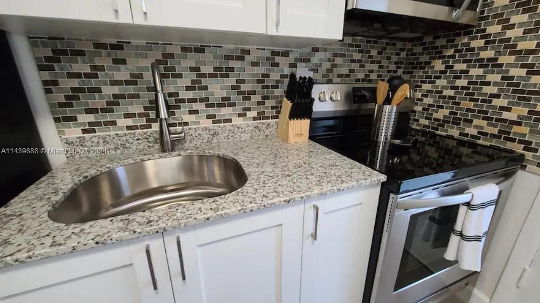 649 Southwest 9th Street, Unit 108 Miami, FL 33130 - Photo 6 of 7 a kitchen with a sink and cabinets