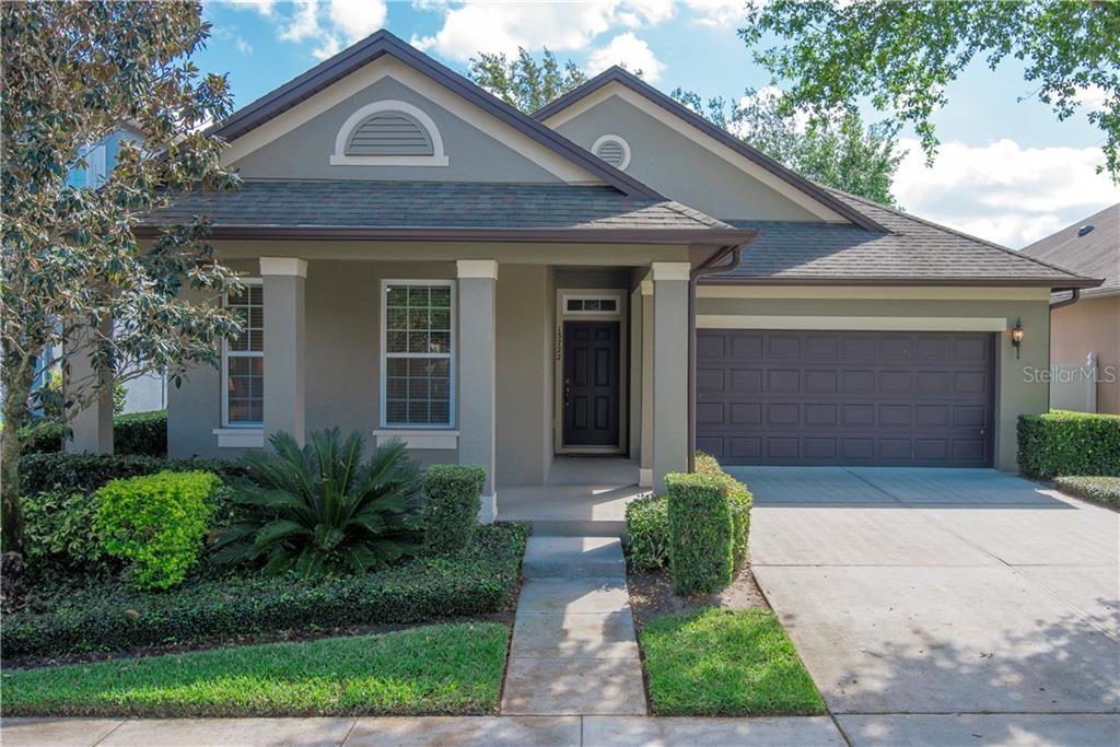 13722 Darchance Road Windermere, FL 34786 - Photo 1 of 1 Front view of 13722 Darchance with a front porch, gutters, 2 car garage, and mature landscaping.