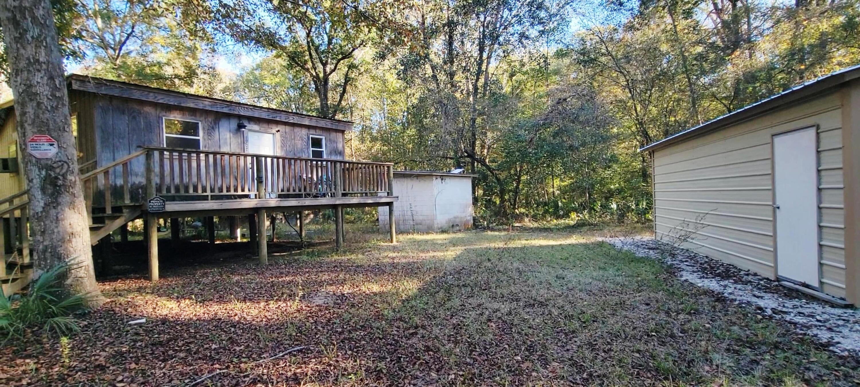 1907 River Road Ponce de Leon, FL 32455 - Photo 16 of 63 a backyard of a house with table and chairs