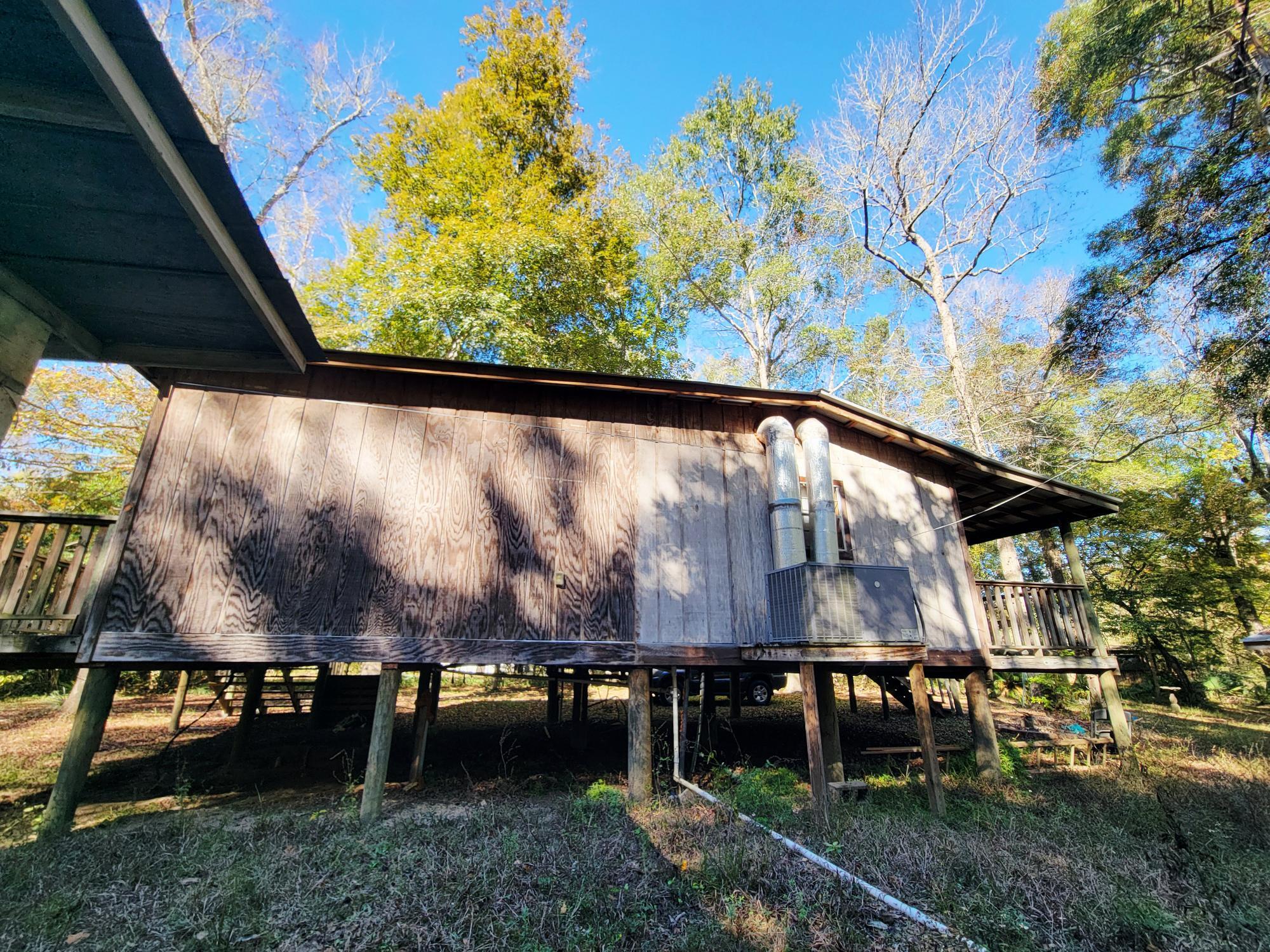 1907 River Road Ponce de Leon, FL 32455 - Photo 17 of 63 a view of outdoor space with seating area and trees around
