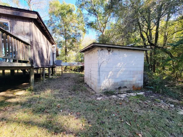 a front view of a house with a yard table and chairs