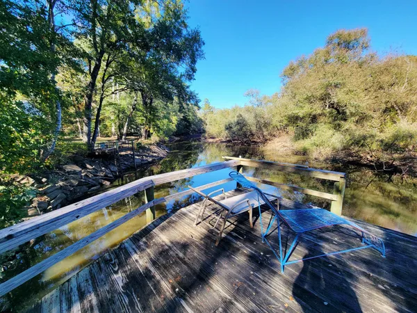 a view of balcony with wooden floor and fence