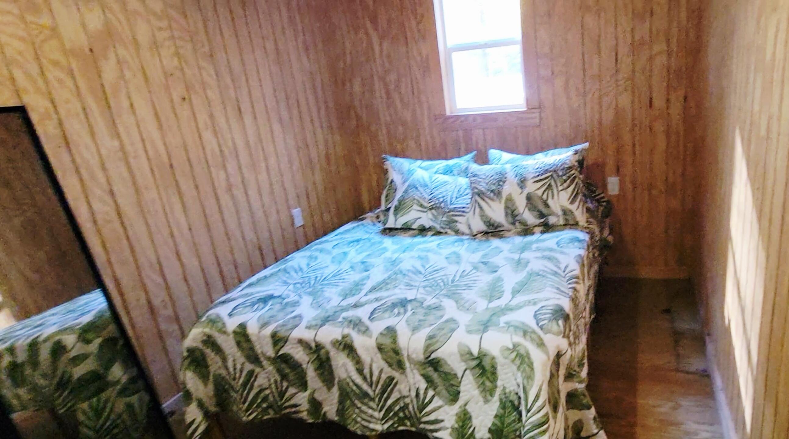 1907 River Road Ponce de Leon, FL 32455 - Photo 42 of 63 a bed sitting in a bedroom next to a window