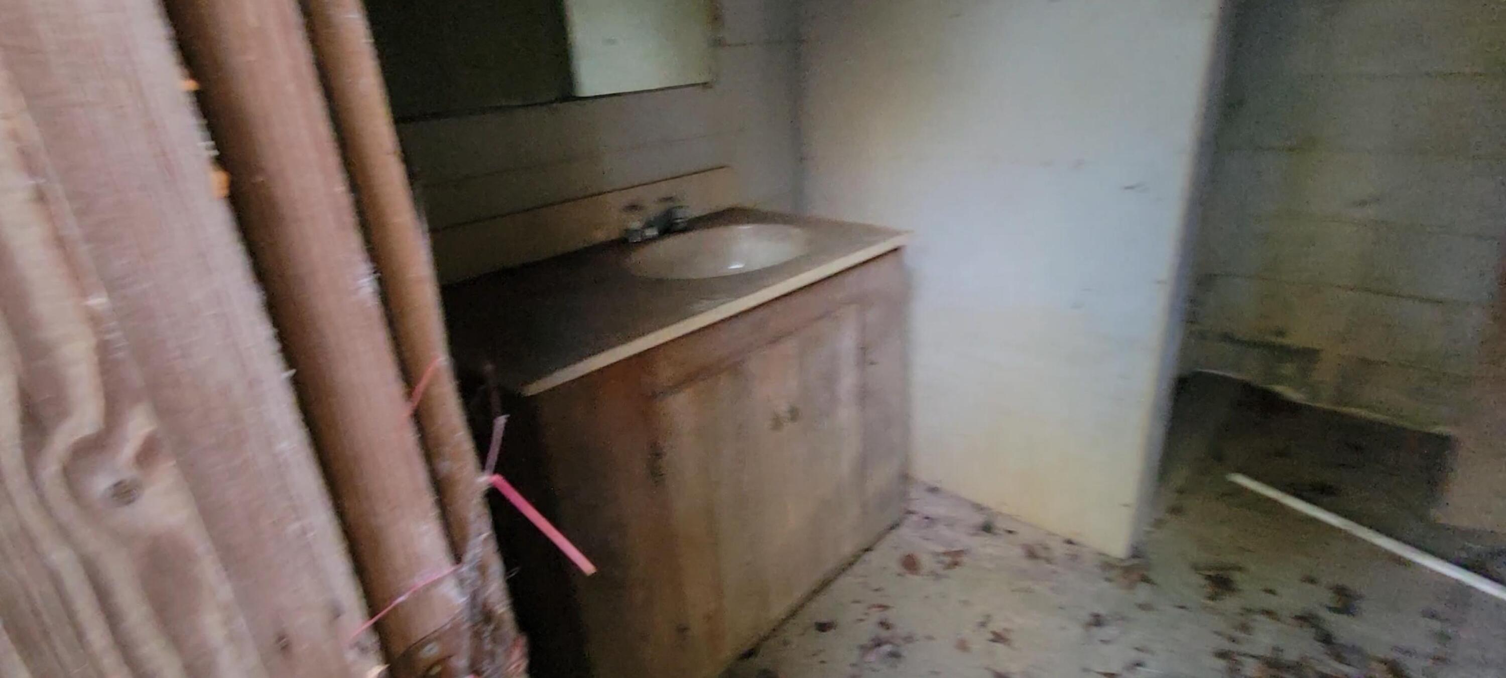 1907 River Road Ponce de Leon, FL 32455 - Photo 51 of 63 a bathroom with a sink a toilet and a shower curtain