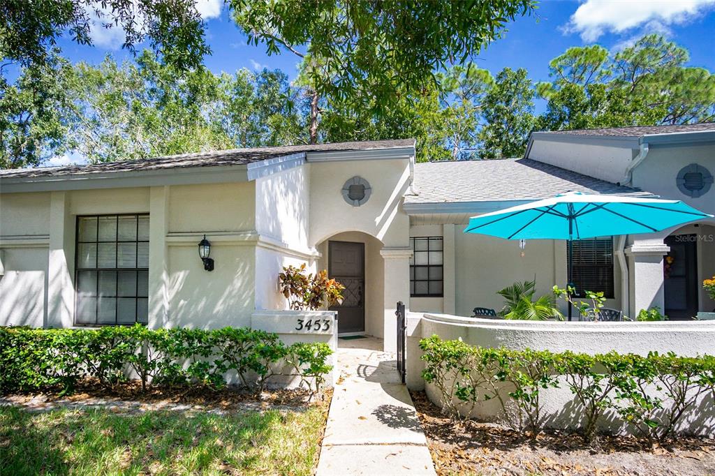 an aerial view of a house with a yard and potted plants