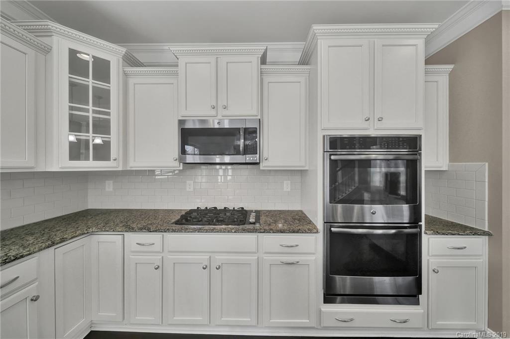 264 Annatto Way Tega Cay, SC 29708 - Photo 13 of 36 a kitchen with white cabinets and appliances