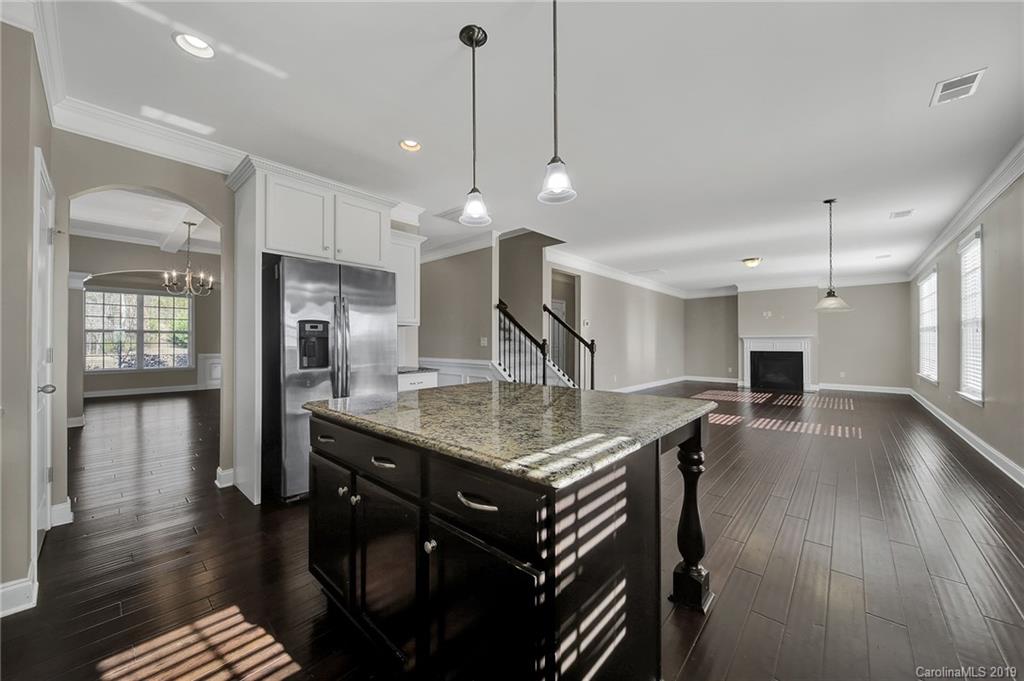 264 Annatto Way Tega Cay, SC 29708 - Photo 14 of 36 a kitchen with center island and stainless steel appliances