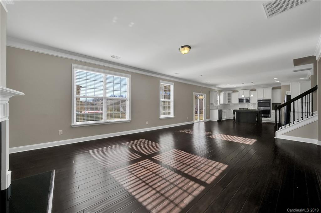 264 Annatto Way Tega Cay, SC 29708 - Photo 15 of 36 a view of an empty room with wooden floor and a window