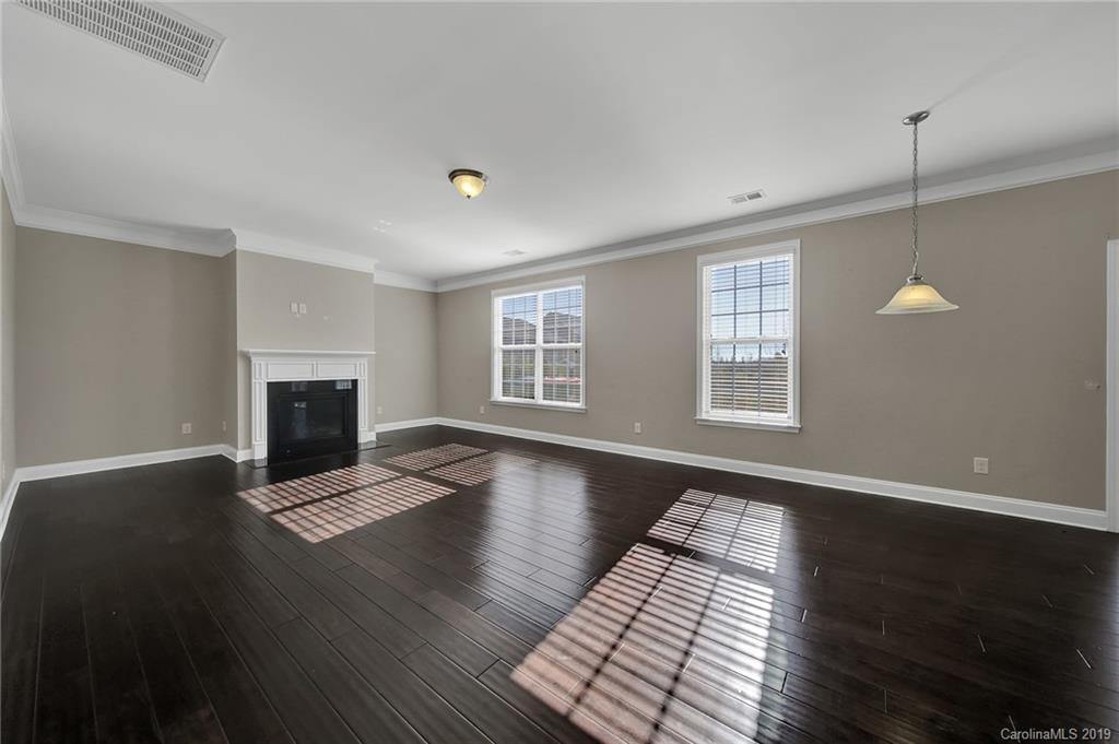 264 Annatto Way Tega Cay, SC 29708 - Photo 16 of 36 a view of an empty room with wooden floor and a window