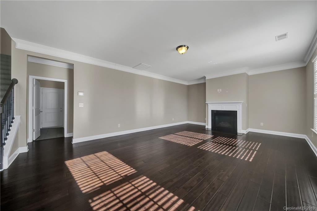 264 Annatto Way Tega Cay, SC 29708 - Photo 17 of 36 a view of an empty room with wooden floor fireplace and a window